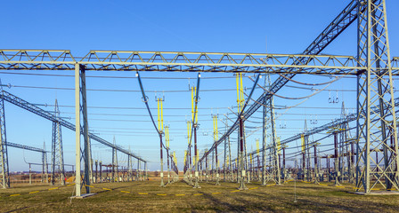 Fototapeta premium transformer station in rural landscape with blue sky