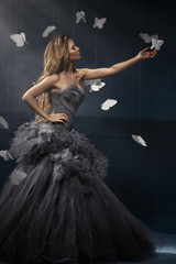 Beauty blonde woman on the fog with butterflies