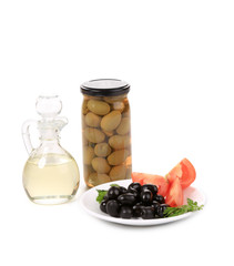 Bottle and bowl of olives with vinegar.