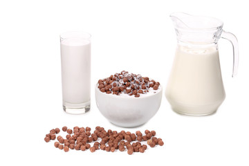 Cereal in bowl and glass carafe with milk.