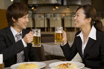 man and woman in suit with beer mug