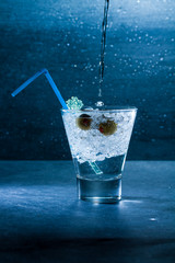 Gin Cocktail with crushed ice and olives