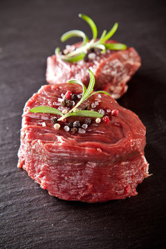 Fresh beef raw steaks on black stone