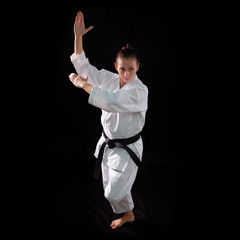 karate girl with black belt posing, champion of the world, on bl