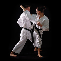 fighting karate couple, man and woman with black belts - champio © Khorzhevska