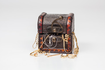 Old wooden chest with gold chain and ring