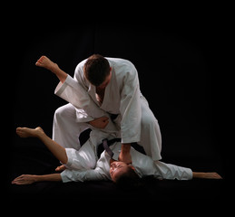 fighting karate couple - champions of the world - on black backg
