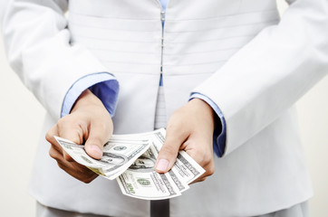 Businesswoman counting US currency in hands