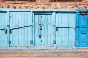 Blue doors locked with padlocks