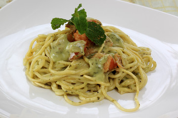 Spaghetti and salmon in pesto sauce
