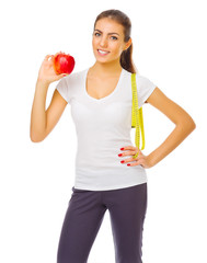 Young sporty girl with apple and measurement tape