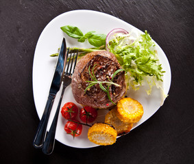 Fresh beef steak on black stone