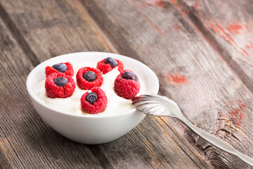 Fresh raspberries and blueberries with yogurt