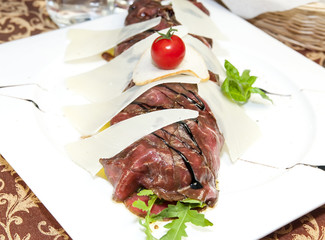 carpaccio at a restaurant on a white background