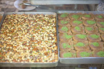 two brass plates of different turkish sweets