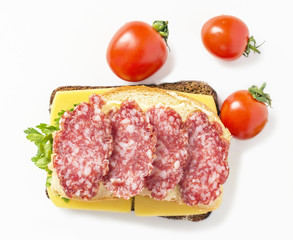 one sandwich with salami and cheese and tomatoes