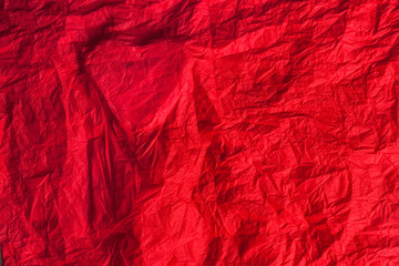 Silhouette of the heart on a red crumpled paper