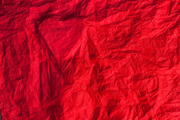 Fototapeta premium Silhouette of the heart on a red crumpled paper