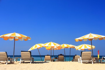 clear blue sky with beach umbrella