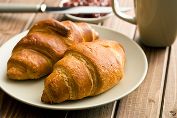 two croissants on wooden table