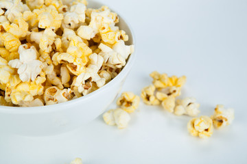 dish with popcorn on white