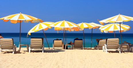 clear blue sky with beach umbrella