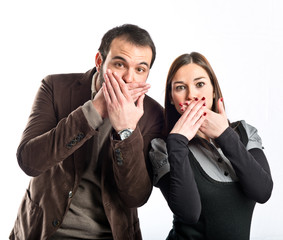 Couple doing surprise gesture over white background
