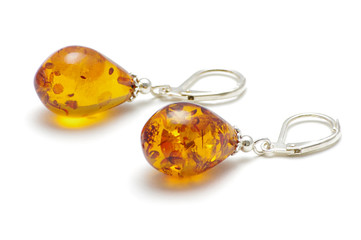 Golden color Baltic amber earrings isolated