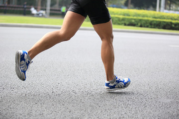 Fototapeta premium marathon athletes legs running on street 