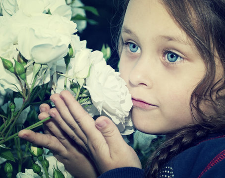 Child Smelling Flowers