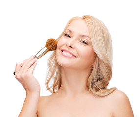 beautiful woman with closed eyes and makeup brush