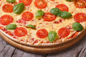 half pizza margarita on the old wooden table