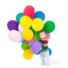 Fototapeta na wymiar Cute baby playing with party balloons