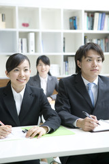 male and female new employees gaining on-the-job training