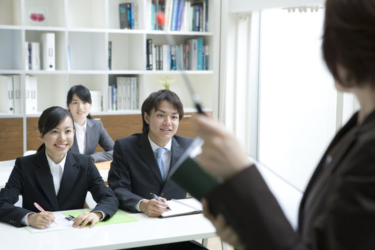 male and female new employees gaining on-the-job training