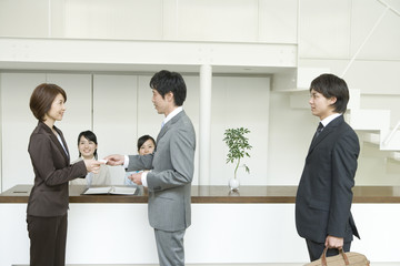 Fototapeta premium man handing business card