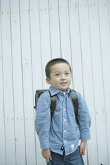 boy carrying a satchel on his back