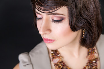closeup portrait of a girl with makeup on black background