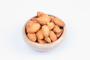 Almonds in bowl isolated on white background