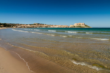 View of the citadel and port of Calvi from across Calvi bay