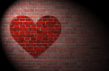 Red heart on brick wall