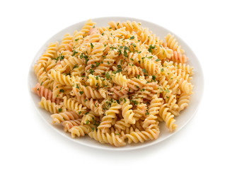 pasta fusilli in plate on white