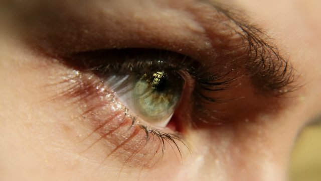 A girl eye wearing cosmetic contact lens (Gold).