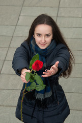 Nice girl wants to compliment with red rose