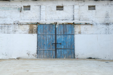 wall of ancient wooden barn with door