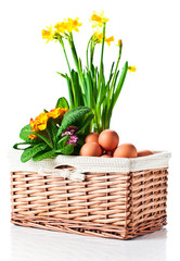 basket with spring flowers and eggs