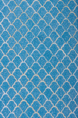 The blue ceramic tiles on the wall with wave pattern