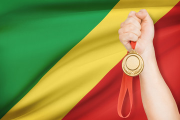 Medal in hand with flag on background - Republic of the Congo