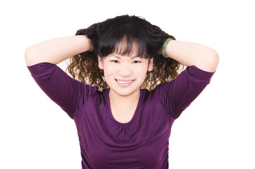 Young woman with brown curly hair on white background