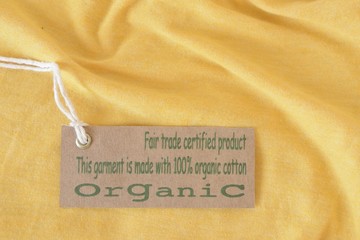 Yellow garment with certified organic fabric label.